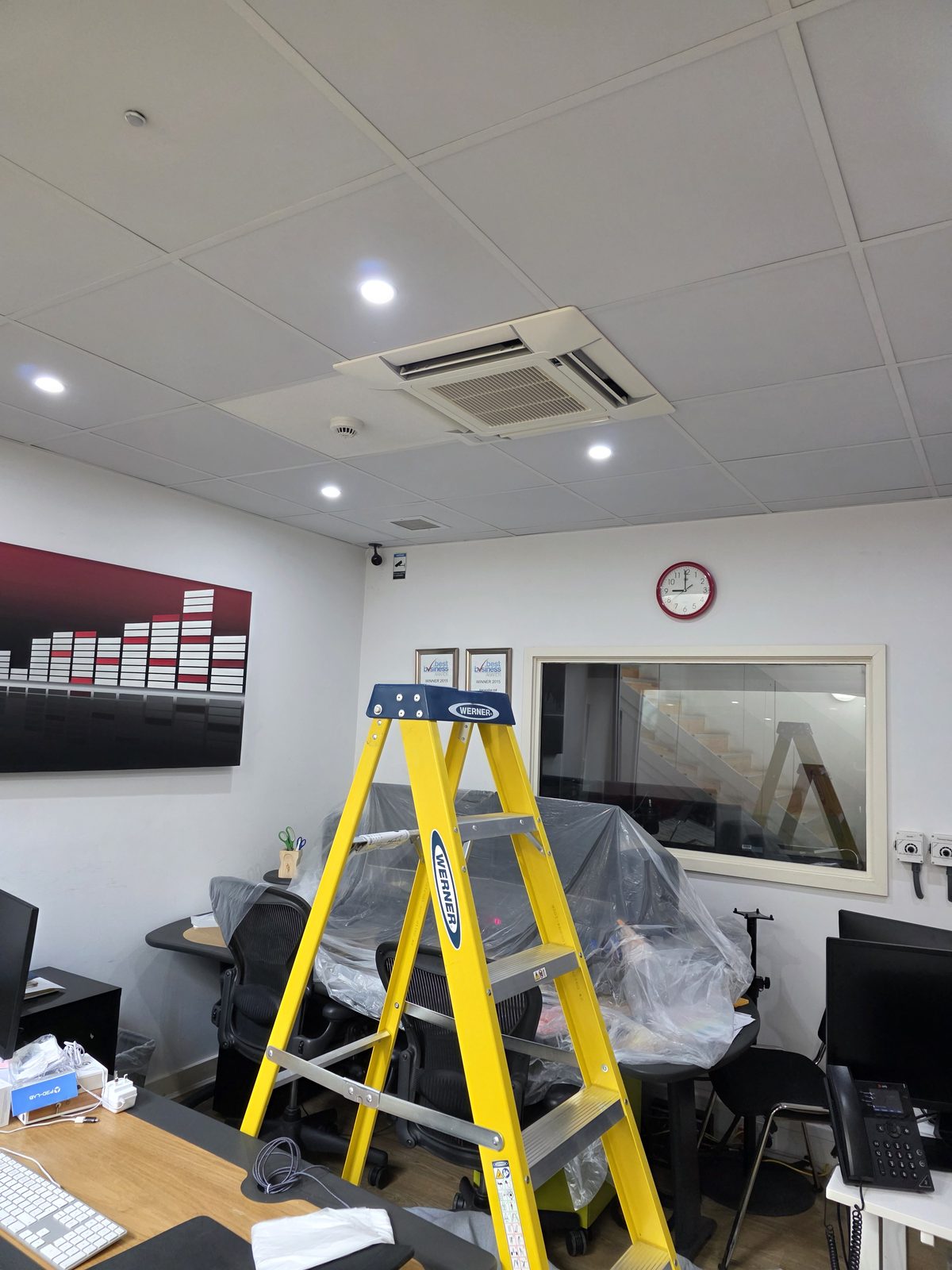 Ceiling cassette air conditioning being serviced in a Stockwell studio