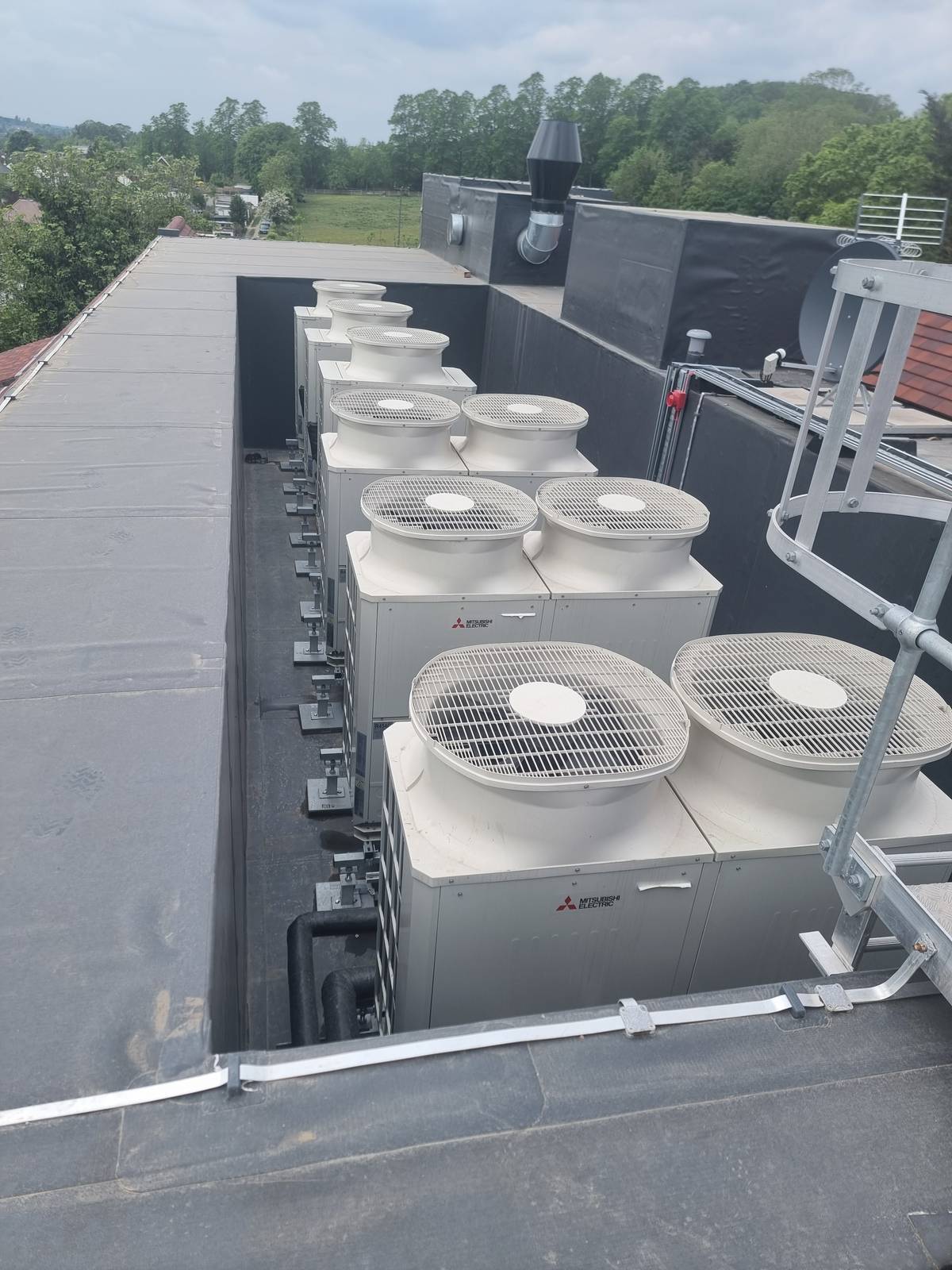 Commercial air source heat pumps on a flat roof in Bromley