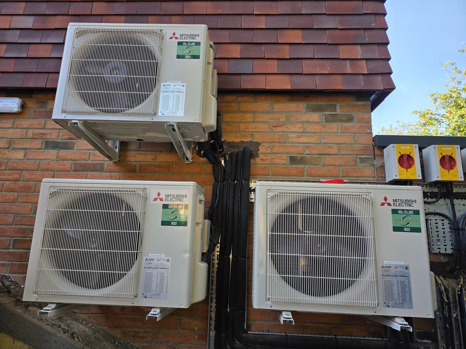 Three Mitsubishi Mr. Slim outdoor air conditioning units in Bromley